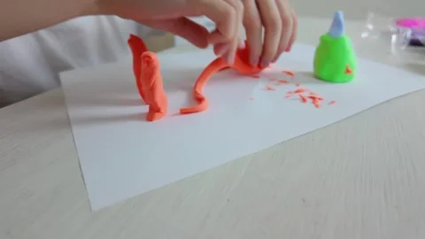 Engaging in Creative Play Using Colorful Modeling Clay to Form Fun and Stock Footage 301439354