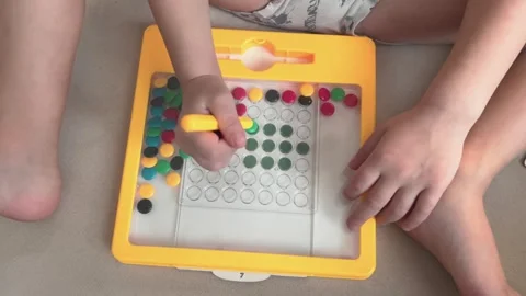 Engaging in Creative Play Using a Colorful Learning Toy Perfect for Kids Stock Footage 320847193