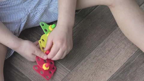 Engaging in Creative Play using Colorful Building Toys specifically designed for Stock Footage 320950610