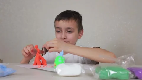 Engaging in creative play with vibrant modeling clay is an enjoyable activity Stock Footage 301439334