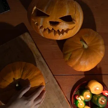 Engaging in Creative Pumpkin Carving for Unique Halloween Decor and Festive Stock Photos