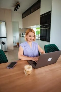 Engaging in creative work from a stylish kitchen space Stock Photos