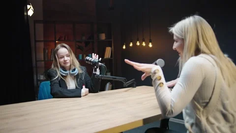 Engaging discussion between two women in a podcast studio Stock Footage 304423628
