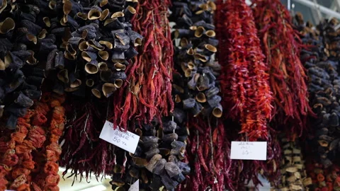 An engaging display of vibrant dried peppers and herbs hung up Stock Footage 325397947