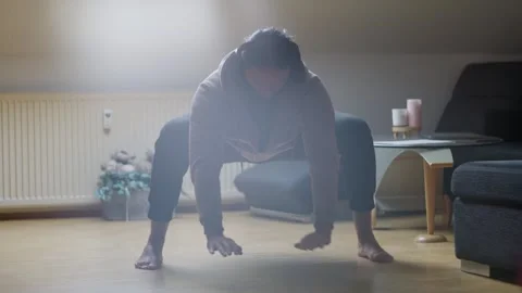 Engaging in Dynamic Mobility Exercises within the Comforts of Your Home Stock Footage 308663420
