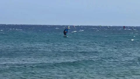 Engaging Dynamic Surfing Scene Over Stunningly Clear and Crystal Blue Waters of Stock Photos