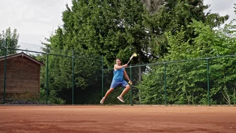 Engaging in a Dynamic Tennis Practice Session on a Clay Court for improved Stock Footage 313224835