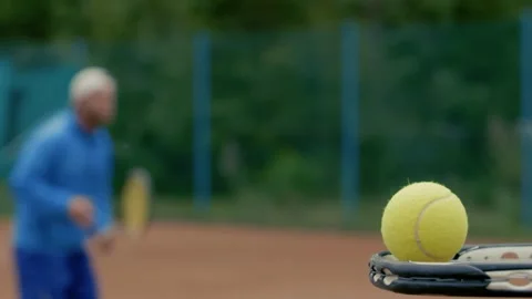 Engaging in Dynamic Tennis Training on a Clay Court for improved skills and Stock Footage 285605774