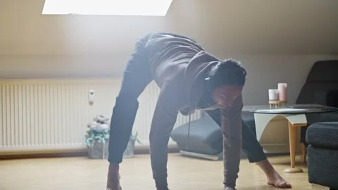 Engaging in Dynamic Yoga Poses within a Cozy and Inviting Living Room Stock Footage 308927819