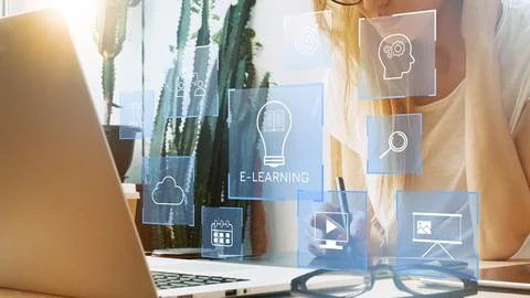 Engaging in e learning activities at home while using a laptop and digital Stock Photos