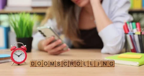 Engaging in endless scrolling at a desk while losing track of time in a bright Stock Footage 320533791
