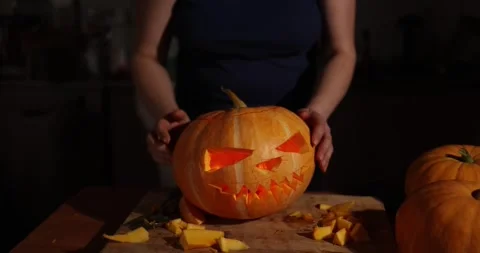 Engaging in the exciting and creative process of Halloween pumpkin carving is Stock Footage 285918092