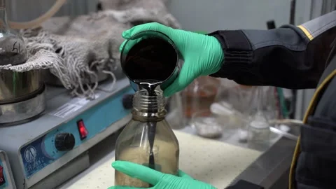 Engaging in an Experiment with Various Liquids within a Controlled Laboratory Video stock 300489674