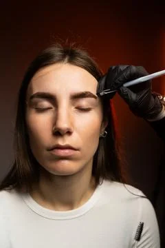 An engaging eyebrow styling session showcasing precision and artistry through Stock Photos