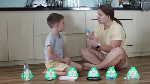 Engaging family activity on sorting garbage at home for cleaner planet. Stock Footage 294181457