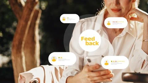Engaging with feedback while using a smartphone outdoors in a park setting Stock Photos