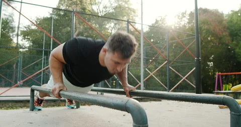 Engaging in a Focused Workout Calisthenics PushUps to Build Strength and Stock Footage 317756427