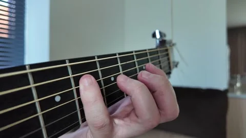 Engaging in Guitar Chord Practice in a Warm and Cozy Setting Stock Footage 315160508