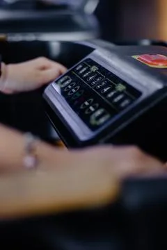 Engaging with High-Tech Treadmill Console for Optimal Workout Control Stock Photos