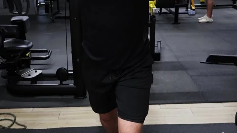 Engaging in intense cable exercises for upper body strength in a gym setting Vídeos de archivo 295280487