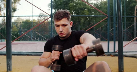 Engaging in an Intense Dumbbell Workout while enjoying the beauty of a Scenic Stock Footage 318074460
