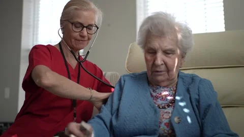 Engaging Interaction Between Caregiver and Elderly Woman in Healthcare Setting Stock Footage 306382001