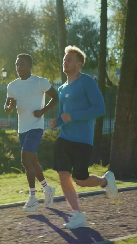 Engaging in the invigorating activity of running while enjoying the warm Stock Footage 314956184