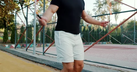 Engaging in a Jump Rope Workout for Enhanced Fitness While Dressed in Athletic Stock Footage 317756305
