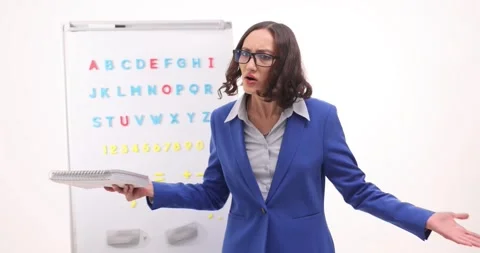 Engaging language lesson in a bright classroom with enthusiastic teacher sharing Stock Footage 321586839