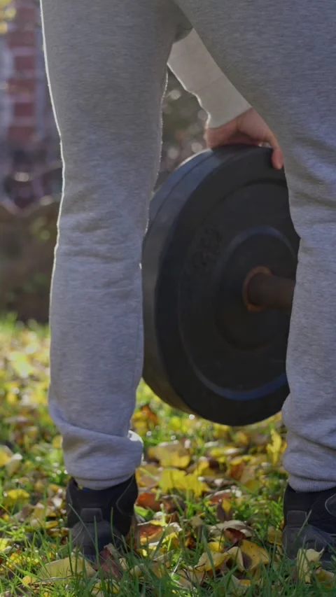 Engaging in Lifting Weights Outdoors Strength Training While Enjoying Natures Stock Footage 308111192