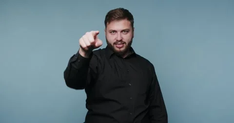Engaging man points confidently at the audience while showcasing his charis.. Stock Footage 329111547
