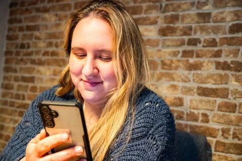 Engaging in a moment of connection while scrolling through a phone in a coz.. Stock Photos