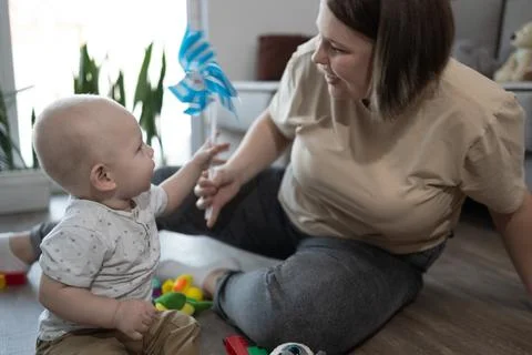 Engaging Playtime Filled with Joy and Love Between a Caring Mother and Her Stock Photos