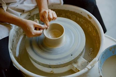 Engaging in the process of crafting exquisite ceramic pottery using a wheel Stock Photos