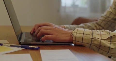 Engaging in productive laptop work while actively typing with hands on a stylish Stock Footage 310519887