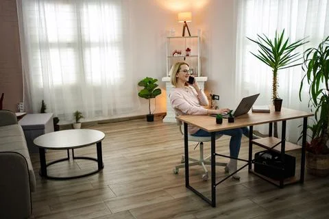 Engaging in a productive remote work session in a modern and bright home office Stock Photos