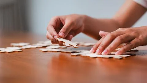 Engaging puzzle solving activity home hobbies indoor close-up focus mindful.. Stock Photos