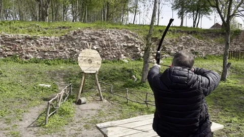 Engaging in Target Practice with a Bow in a Beautifully Scenic Outdoor Setting Stock Footage 304729945