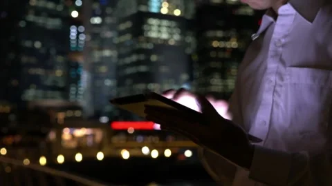Engaging with Technology at Night in the City Stock Footage 314456076