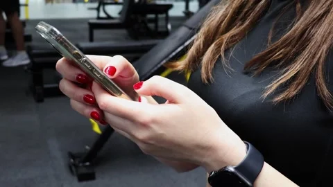 Engaging with technology while working out in a modern fitness center 스톡 동영상 295281731