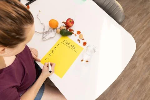 Engaging in Thoughtful Meal Prep with Fresh Ingredients Arranged Neatly on a Stock Photos
