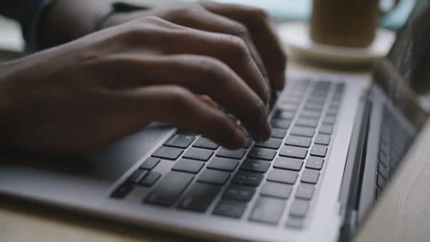 Engaging typing session on laptop with coffee at cozy workspace location Stock Footage 312578130