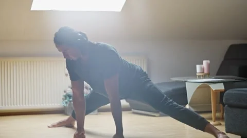 Engaging in a Yoga Pose for Enhanced Flexibility and Strength while Embracing Stock Footage 308663287