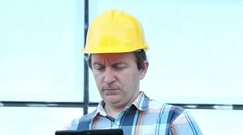 Engeneer with yellow helmet taking notes Stock Footage 58889189