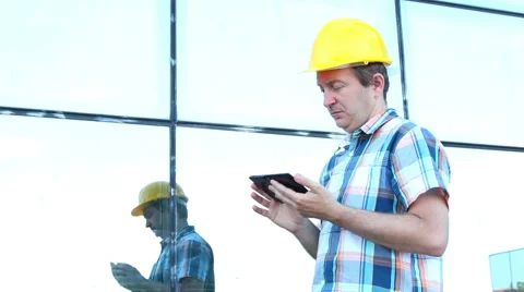 Engeneer with yellow helmet taking notes Stock Footage 58891583