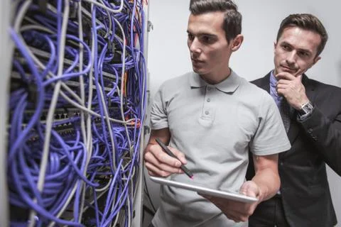Engeneers in network server room Stock Photos
