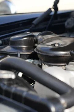 The engine and battery compartment of a classic car, with its detailed mech.. Stock Photos