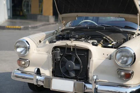 The engine and battery compartment of a classic car, with its detailed mech.. Stock Photos