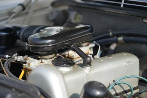 The engine and battery compartment of a classic car, with its detailed mech.. Stock Photos
