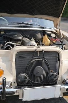 The engine and battery compartment of a classic car, with its detailed mech.. Stock Photos